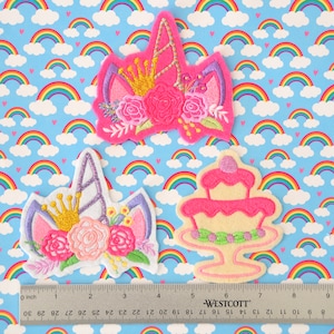 May include: Three embroidered iron-on patches featuring a unicorn head with a crown and flowers, a unicorn head with a crown and flowers, and a pink and white cake with green frosting.