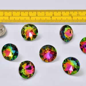 May include: Seven iridescent rainbow-colored round buttons with a star-shaped design. The buttons are approximately 1 inch in diameter.