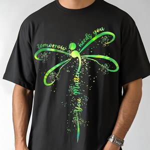 May include: Black t-shirt with a green and yellow dragonfly graphic and the text "tomorrow needs you you matter".
