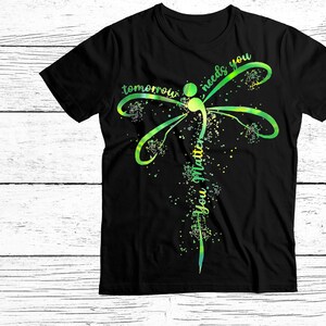 May include: Black t-shirt with a green and yellow dragonfly design. The dragonfly has a semicolon in its body and the text "tomorrow needs you you matter" is written vertically along its body.