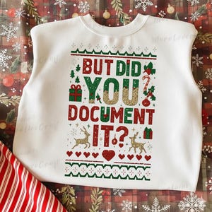 May include: White sleeveless sweatshirt with a festive design. The text "BUT DID YOU DOCUMENT IT?" is in red, green, and gold glitter. The design includes reindeer, hearts, and gift boxes, perfect for the holiday season.