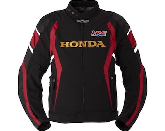 May include: Black motorcycle jacket with red and white accents. The jacket features the Honda Racing Corporation (HRC) logo and the Honda name in gold lettering across the chest. It has a zippered front and multiple pockets.