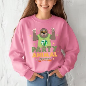 A woman wearing a pink sweatshirt with a cartoon sloth and the text "Party Animal" printed on it.