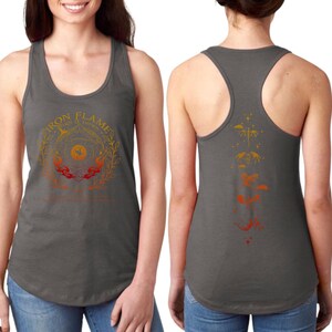 A woman wearing a gray tank top with a graphic design on the front and back.