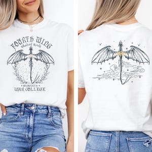 a woman wearing a white t-shirt with a graphic design of a dragon and the text "Fourth Wing" printed on it.