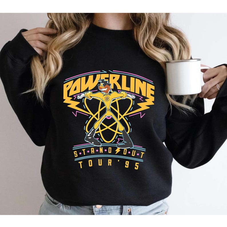 May include: Black sweatshirt with a yellow cartoon character in a superhero pose. The text "POWERLINE STAND OUT TOUR '95" is printed on the front of the sweatshirt.