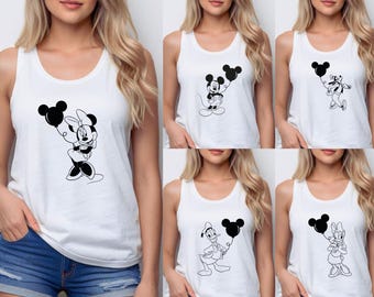 May include: White tank tops featuring black and white cartoon character designs. The designs include Minnie Mouse, Mickey Mouse, Goofy, Donald Duck, and Daisy Duck, each holding a balloon with Mickey Mouse ears. The tank tops are sleeveless.