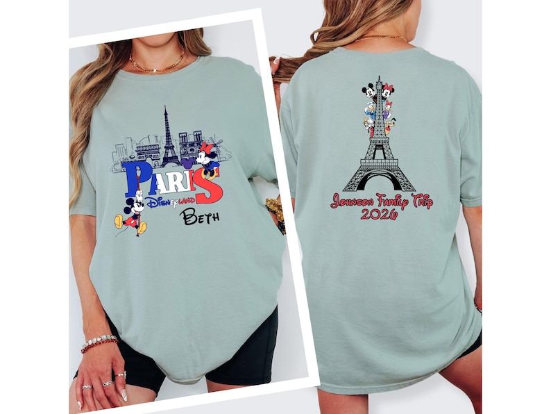 a woman wearing a grey t-shirt with a Paris-themed design, including the Eiffel Tower and Mickey Mouse.