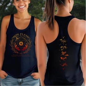 A woman wearing a black tank top with a graphic design on the front and back.