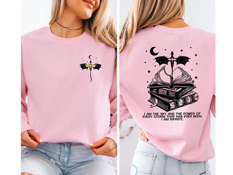 A woman wearing a pink long-sleeved shirt with a dragon design and a quote on the back.
