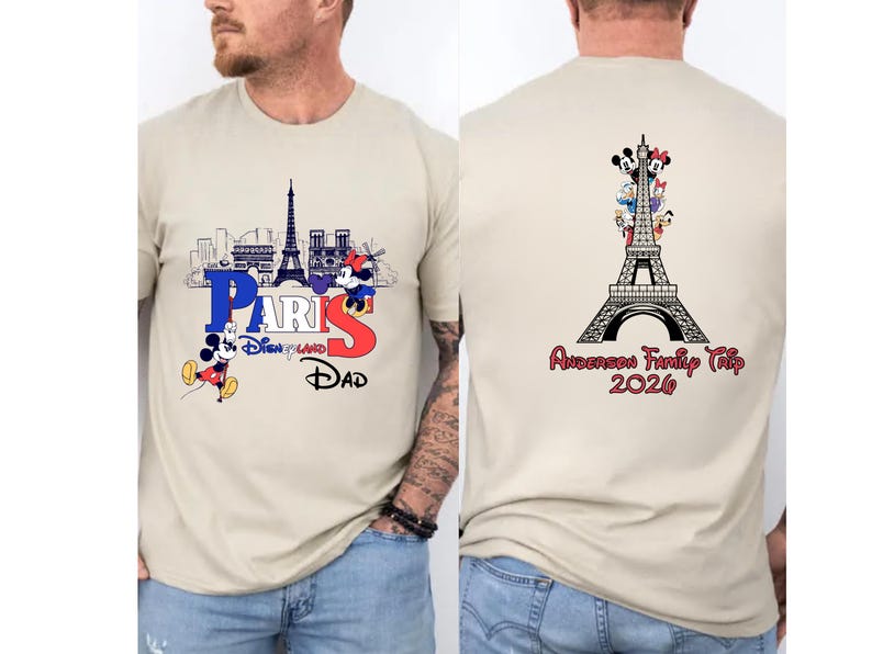 a man wearing a beige t-shirt with a graphic design featuring the Eiffel Tower and Mickey Mouse. The design includes the text "PARIS" and "Disneyland" along with the text "DAD" and "Andrea's Family Trip" printed on the back of the shirt.