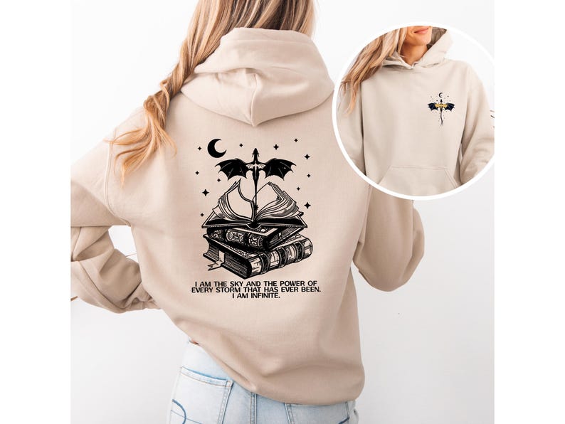 A woman wearing a beige hoodie with a graphic design on the back.