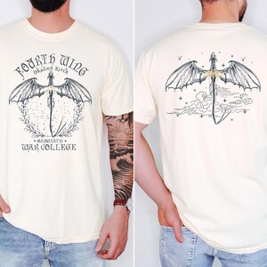 a man wearing a white t-shirt with a graphic design featuring a dragon and text. The design is on the front and back of the t-shirt, and the man has tattoos visible on his arms.