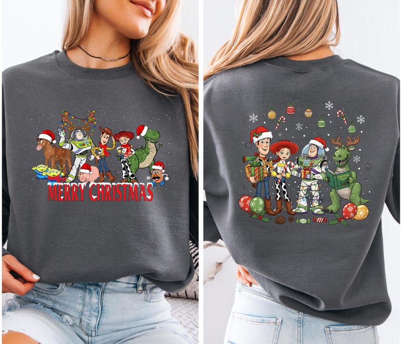 May include: Dark gray sweatshirt featuring a festive graphic of animated characters in Santa hats and Christmas lights. The front of the sweatshirt reads "Merry Christmas" in red. The back of the sweatshirt also features the same characters.