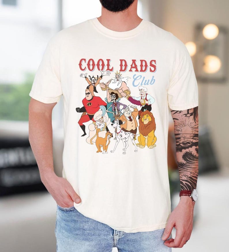 A person wearing a white t-shirt with a graphic design featuring various cartoon characters, including a lion, a dog, and other animals.