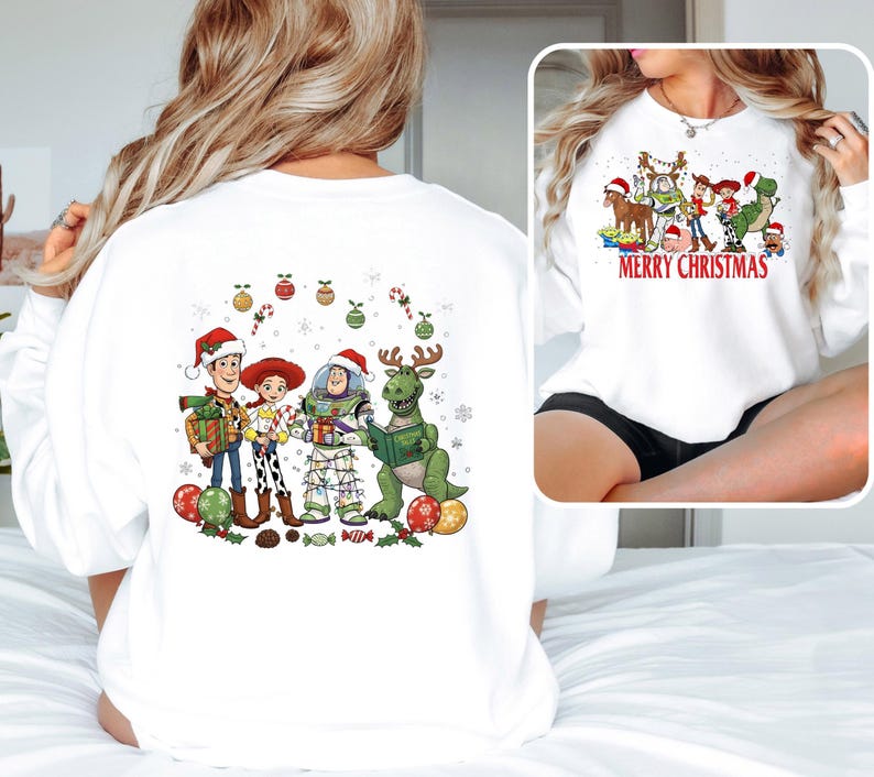May include: White sweatshirt featuring a colorful graphic of Toy Story characters in Santa hats and Christmas decorations. The front of the sweatshirt has the text "MERRY CHRISTMAS". The back of the sweatshirt has the same characters and decorations.
