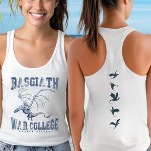A woman wearing a white tank top with a graphic of a dragon and the text "BASGIATH WAR COLLEGE DRAGON RIDERS" printed on it, standing in front of a beach with palm trees and a blue sky.