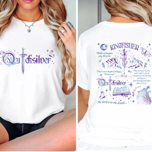 a woman wearing a white t-shirt with a design on the back.