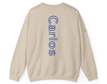 May include: A beige sweatshirt with a blue "CARLOS" logo printed vertically down the back.