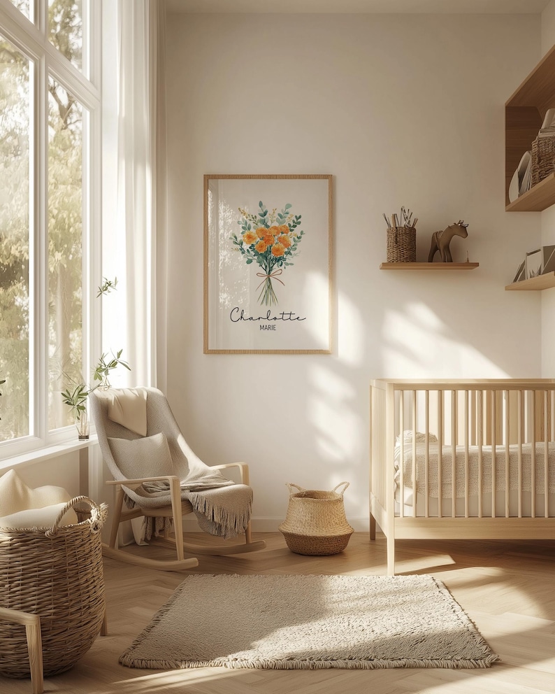 May include: A framed floral print with orange and green flowers, the name "Charlotte" and "Marie" in script. The print hangs above a rocking chair and a crib in a nursery. A woven basket and rug are in the foreground.