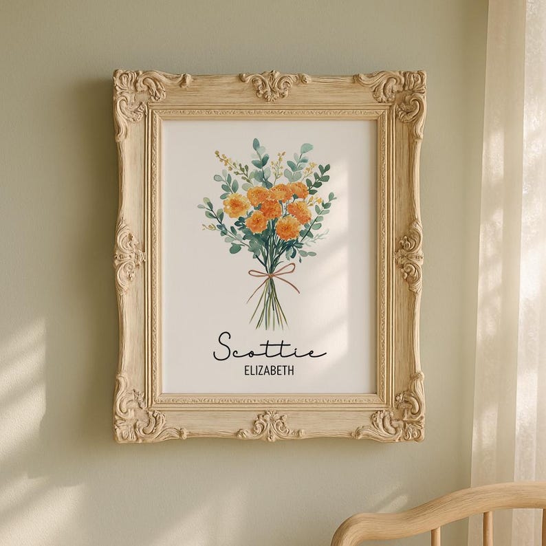 May include: A framed floral print featuring a watercolor bouquet of orange flowers and green foliage tied with a brown ribbon. The print is in a cream-colored ornate frame. The name "Scottie" and "Elizabeth" are written below the bouquet.