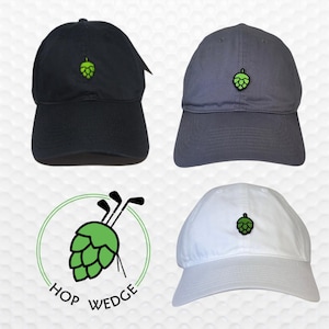 May include: Three baseball caps with a green hop and golf club logo embroidered on the front. The caps are in black, gray, and white.