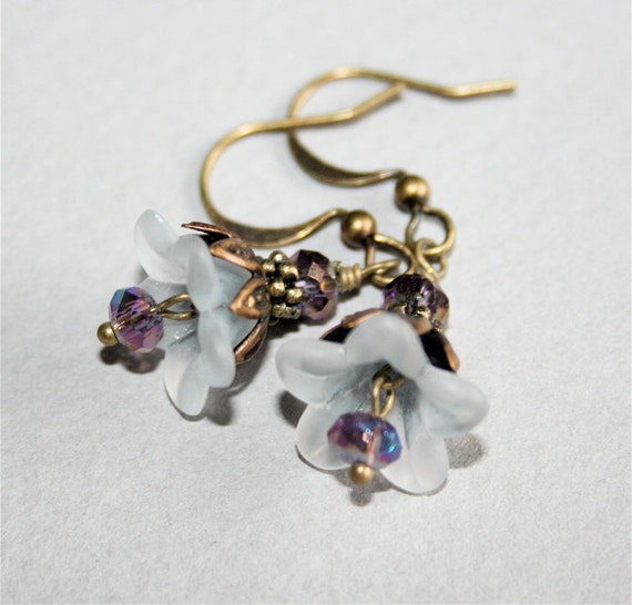 Items similar to White Flower Earrings with Purple Crystal on Etsy