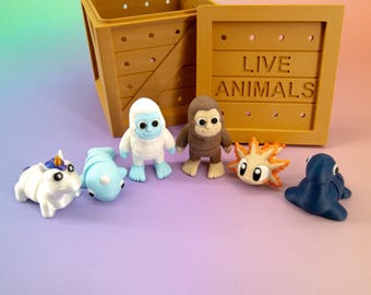 Pocket Pals Weird & Wonderful – Mini Mythical and Cryptid Set + “LIVE ANIMALS” Crate (Unicorn, Yeti, Bigfoot, Nessie, Axolotl, Narwhal)