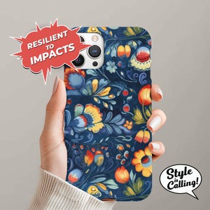 May include: A phone case with a blue background and a colorful floral pattern. The case has a cutout for the camera lens and is designed to protect the phone from impacts.