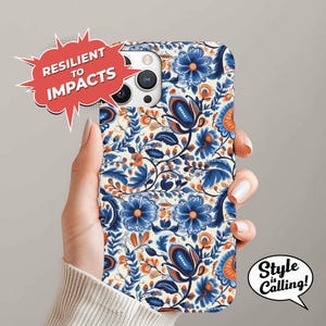 May include: A white phone case with a blue and orange floral pattern. The case is designed to protect the phone from impacts. The text "Resilient to Impacts" is on a red speech bubble.