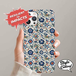 May include: A white phone case with a blue and red floral pattern. The case is designed to be resilient to impacts. The text "Style is Calling!" is on a white speech bubble.