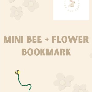 May include: A beige background features a handmade bookmark with a bee and flower design. The bookmark has a yellow and black bee, a green stem, and a pink flower. There are also several white flower-shaped embellishments. The text "MINI BEE + FLOWER BOOKMARK" is displayed.