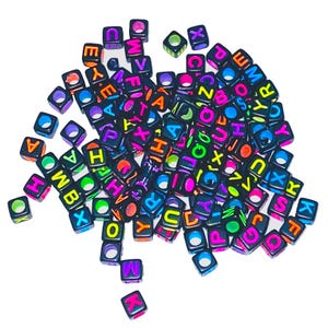 May include: A large pile of black letter beads with neon colored letters. The letters are in a random order and include the letters A, B, C, D, E, F, G, H, I, J, K, L, M, N, O, P, Q, R, S, T, U, V, W, X, Y, and Z.