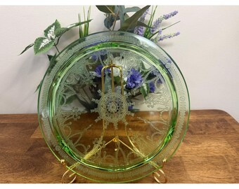 Talerz ze szkła uranowego z wytrawionym wzorem świeci pod wpływem światła UV z okresu depresji