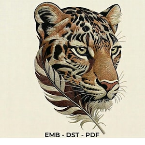 May include: Embroidered image of a jaguar's head with a feather. The jaguar has brown and black spots, with green eyes and a pink nose. The feather is brown and white. The text "EMB - DST - PDF" is at the bottom.
