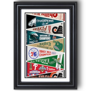 May include: Framed print featuring pennants celebrating Philadelphia sports teams. Includes the Eagles, Flyers, Phillies, and 76ers. Each pennant displays team logos, championship years, and the words "Champions" and "World Series". The frame is black.