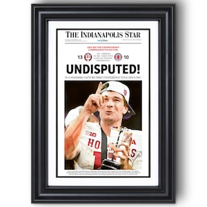 May include: Framed newspaper front page from The Indianapolis Star, commemorating the 2025 Big Ten Championship. Headline: "UNDISPUTED!" with a photo of a player holding a trophy. The score is 13-0, with the text "13-0 Hoosiers capture first conference title since 1967."