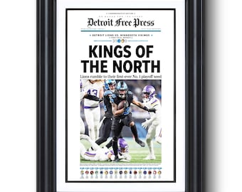 May include: A Detroit Free Press commemorative newspaper headline reads "Kings of the North" with a photo of a football player running with the ball. The headline says "Lions rumble to their first-ever No. 1 playoff seed".