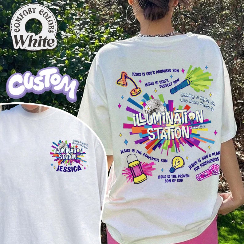 May include: White t-shirt with a colorful "ILLUMINATION STATION" graphic. The design includes text and illustrations of a lamp, flashlight, and lantern. The shirt also features the text "JESUS IS GOD'S PROMISED SON".