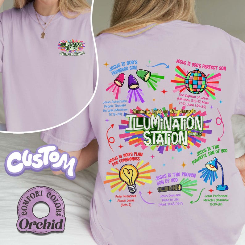 May include: A light purple t-shirt with the text "ILLUMINATION STATION" and various religious graphics. The shirt also features the text "Church Name" and "Comfort Colors Orchid".