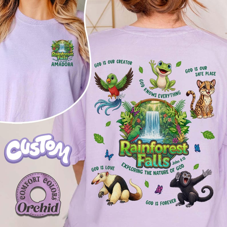 May include: A lilac t-shirt with a graphic featuring a waterfall, animals, and the text "Rainforest Falls." The shirt also has the text "Exploring the Nature of God" and "John 8:12."