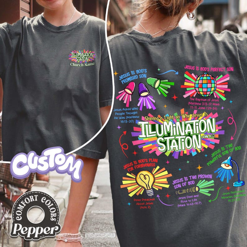 May include: Dark gray t-shirt with the text "ILLUMINATION STATION" and colorful graphics. The back of the shirt features religious text and illustrations, including a disco ball and a lightbulb.