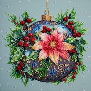 May include: A beaded Christmas ornament with a poinsettia flower and red berries. The ornament is blue and gray with gold accents, surrounded by green foliage. The background is a light blue with white dots.