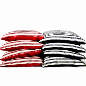 May include: A set of eight bean bags for playing cornhole. Four bean bags are red with white stripes and four bean bags are navy blue with white stripes.