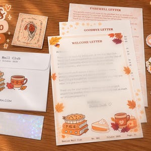 May include: A stationery set featuring a white envelope with a pie and mug illustration, a welcome letter with autumn leaf borders, a farewell letter, a small card with a heart illustration, three die-cut stickers, and a rectangular bookmark.