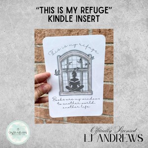 May include: A white Kindle insert with a window design, featuring a silhouette of a person reading. The text reads "This is my refuge" and "Books are my windows to another world, another life."