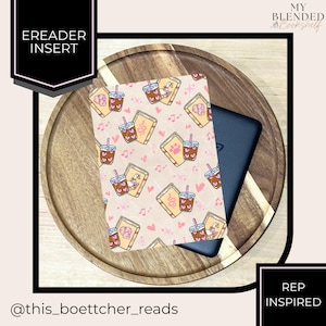 May include: An eReader insert with a repeating pattern of books, coffee drinks, paw prints, musical notes, and hearts. The insert is on a wooden tray with a black eReader. Text on the insert reads "EREADER INSERT". The text "MY BLENDED Bookshelf" is also visible.
