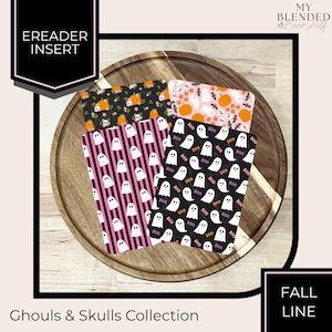 May include: Four rectangular ereader inserts featuring Halloween patterns. One has black background with pumpkins and flowers, one has pink background with ghosts and pumpkins, one has pink and black stripes with ghosts, and one has black background with ghosts and the text BOO.
