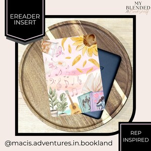May include: An e-reader insert with a watercolor design featuring a sunflower, musical notes, books, and a guitar. The insert is placed on a wooden tray with a decorative border. Text on the insert reads "Ereader Insert" and "Rep Inspired".