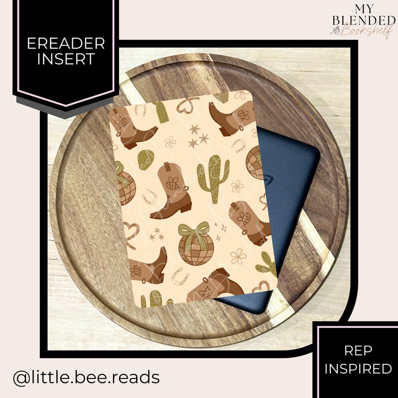 May include: An e-reader insert with a beige background featuring brown cowboy boots, cacti, and other western-themed illustrations. The insert is placed on a wooden tray with a dark blue e-reader peeking out from behind it. Text on the insert reads "EREADER INSERT".